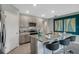 Modern kitchen with granite counters, stainless appliances, and adjacent dining area at 1705 Three Bars Rd, Kissimmee, FL 34744