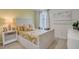 Stylish bedroom with a white bed frame, accent pillows, and natural lighting at 1706 Three Bars Rd, Kissimmee, FL 34744