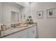 Well-lit bathroom featuring granite countertops, modern fixtures, and framed wall art at 1730 Three Bars Rd, Kissimmee, FL 34744