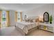 A bedroom with white paneled walls, two windows, and a bed with decorative throw pillows at 1730 Three Bars Rd, Kissimmee, FL 34744