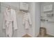 A closet with robes hanging on the rack and storage baskets on the shelves at 1730 Three Bars Rd, Kissimmee, FL 34744