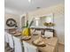 A dining room features a dining table with yellow vases as the centerpiece at 1730 Three Bars Rd, Kissimmee, FL 34744
