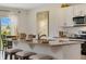 Kitchen boasts white cabinetry, modern appliances, granite countertops, and a breakfast bar at 1730 Three Bars Rd, Kissimmee, FL 34744