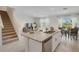 Open floor plan with kitchen island, stainless steel appliances, and living and dining spaces at 1730 Three Bars Rd, Kissimmee, FL 34744