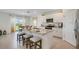 An open kitchen features an island with bar stool seating and stainless steel appliances at 1730 Three Bars Rd, Kissimmee, FL 34744