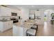 Open kitchen boasts an island with granite countertops, stainless appliances, and ample cabinet space at 1730 Three Bars Rd, Kissimmee, FL 34744