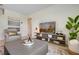 Comfortable living room featuring a modern entertainment center and neutral color palette at 1730 Three Bars Rd, Kissimmee, FL 34744