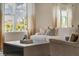 Bright living room features stylish furniture, neutral decor, and large windows with neighborhood views at 1730 Three Bars Rd, Kissimmee, FL 34744