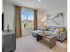 Cozy living room featuring a sectional couch, modern art, and large window with neighborhood views at 1730 Three Bars Rd, Kissimmee, FL 34744