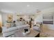Open concept living area connecting to a modern kitchen with a cozy seating arrangement at 1730 Three Bars Rd, Kissimmee, FL 34744