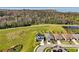 Aerial view of home nestled amongst lush greenery and trees with picturesque neighborhood pond nearby at 1832 Farnham Dr, Ocoee, FL 34761