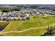 Aerial view showcases a neighborhood surrounded by green space and walking path at 1832 Farnham Dr, Ocoee, FL 34761