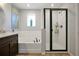 Bathroom features a soaking tub, black trimmed shower, and tiled walls at 1832 Farnham Dr, Ocoee, FL 34761
