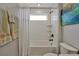 Clean bathroom with a subway-tiled shower and a white shower curtain and towels at 1832 Farnham Dr, Ocoee, FL 34761