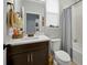 Bright bathroom with a vanity, toilet, and a shower featuring a neutral curtain at 1832 Farnham Dr, Ocoee, FL 34761