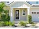 Inviting front entry with a black front door, fresh landscaping, and a brick driveway at 1832 Farnham Dr, Ocoee, FL 34761