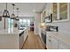 Gourmet kitchen with stainless steel appliances, white cabinetry, and a large island at 1832 Farnham Dr, Ocoee, FL 34761