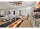 Bright living room features an elegant ceiling fan, a sleek sectional sofa and stylish decor at 1832 Farnham Dr, Ocoee, FL 34761