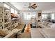 Open-concept living room with a large sectional, stylish decor, and sun-filled windows at 1832 Farnham Dr, Ocoee, FL 34761