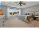 Bright main bedroom with tray ceiling, large windows, and stylish furniture at 1832 Farnham Dr, Ocoee, FL 34761