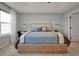 Bright main bedroom features a tray ceiling, window, and comfortable looking bed at 1832 Farnham Dr, Ocoee, FL 34761