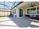 Relax on this covered patio with comfortable seating, ceiling fan, and view of the backyard at 1832 Farnham Dr, Ocoee, FL 34761