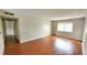 Bright living room featuring hardwood floors and a large window at 1926 S Conway Rd # 12, Orlando, FL 32812