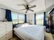 Well lit bedroom with a ceiling fan, two windows, and a queen sized bed at 200 Dr Martin Luther King Jr Se St, Fort Meade, FL 33841