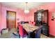 Dining room featuring a crystal chandelier, and red upholstered chairs surrounding a marble table at 200 Dr Martin Luther King Jr Se St, Fort Meade, FL 33841