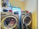 Convenient laundry area features modern washer and dryer units, and handy storage shelves at 200 Dr Martin Luther King Jr Se St, Fort Meade, FL 33841