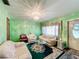 Bright living room featuring light green walls, plush couches, and a decorative chandelier at 200 Dr Martin Luther King Jr Se St, Fort Meade, FL 33841