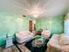 Cozy living room featuring light green walls, plush couches, and a decorative chandelier at 200 Dr Martin Luther King Jr Se St, Fort Meade, FL 33841