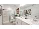 Well-lit bathroom with double sinks, modern fixtures, and a glass-enclosed shower for a spa-like experience at 2500 Penguin Blvd, Davenport, FL 33837