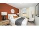 Charming bedroom with a decorative orange accent wall, large window and stylish decor at 2500 Penguin Blvd, Davenport, FL 33837