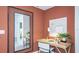 Upstairs hallway featuring a small home office with a mirror, desk, chair, and warm paint color at 2500 Penguin Blvd, Davenport, FL 33837