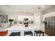 Bright kitchen featuring white cabinets, stainless steel appliances, large island and bar stool seating at 2500 Penguin Blvd, Davenport, FL 33837