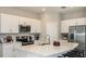Modern kitchen with stainless steel appliances, white cabinets, and a spacious island with seating at 2500 Penguin Blvd, Davenport, FL 33837