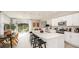 Open kitchen area showing island, stainless steel appliances, and adjacent living area with outdoor access at 2500 Penguin Blvd, Davenport, FL 33837