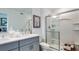 Contemporary bathroom with dual sinks, a sleek vanity, and a glass-enclosed shower for a spa-like experience at 2504 Penguin Blvd, Davenport, FL 33837