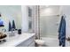 Bright bathroom featuring a modern vanity, patterned shower curtain, and neutral tones at 2508 Penguin Blvd, Davenport, FL 33837