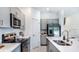 Newly built kitchen features stainless appliances, quartz counters, an island, and modern cabinets at 2512 Penguin Blvd, Davenport, FL 33837