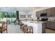 New kitchen boasts quartz island, stainless appliances, stylish cabinets, and adjacent living area at 2512 Penguin Blvd, Davenport, FL 33837