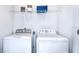 Convenient laundry area with a washer, dryer, and storage shelf at 2512 Penguin Blvd, Davenport, FL 33837