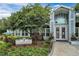 Inviting community clubhouse featuring a beautifully landscaped entrance and a charming architectural design at 2516 Grassy Point Dr # 206, Lake Mary, FL 32746