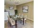 Spacious dining room featuring modern chandelier, glass table set for six, and contemporary artwork at 2516 Grassy Point Dr # 206, Lake Mary, FL 32746