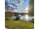 Picturesque lake view featuring reflective waters, a bright sky, and the outline of distant trees at 2516 Grassy Point Dr # 206, Lake Mary, FL 32746