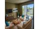Comfortable living room with plush seating, stylish decor, a large window and balcony overlooking a lake at 2516 Grassy Point Dr # 206, Lake Mary, FL 32746