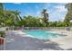 Community pool surrounded by lush greenery and comfortable seating for relaxation and enjoyment at 2516 Grassy Point Dr # 206, Lake Mary, FL 32746