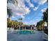 Inviting community pool with clear blue water, surrounded by lounge chairs and lush palm trees at 2516 Grassy Point Dr # 206, Lake Mary, FL 32746