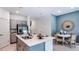 Well-lit kitchen boasts gray cabinets, stainless steel appliances, and a large island with bar seating at 2516 Penguin Blvd, Davenport, FL 33837